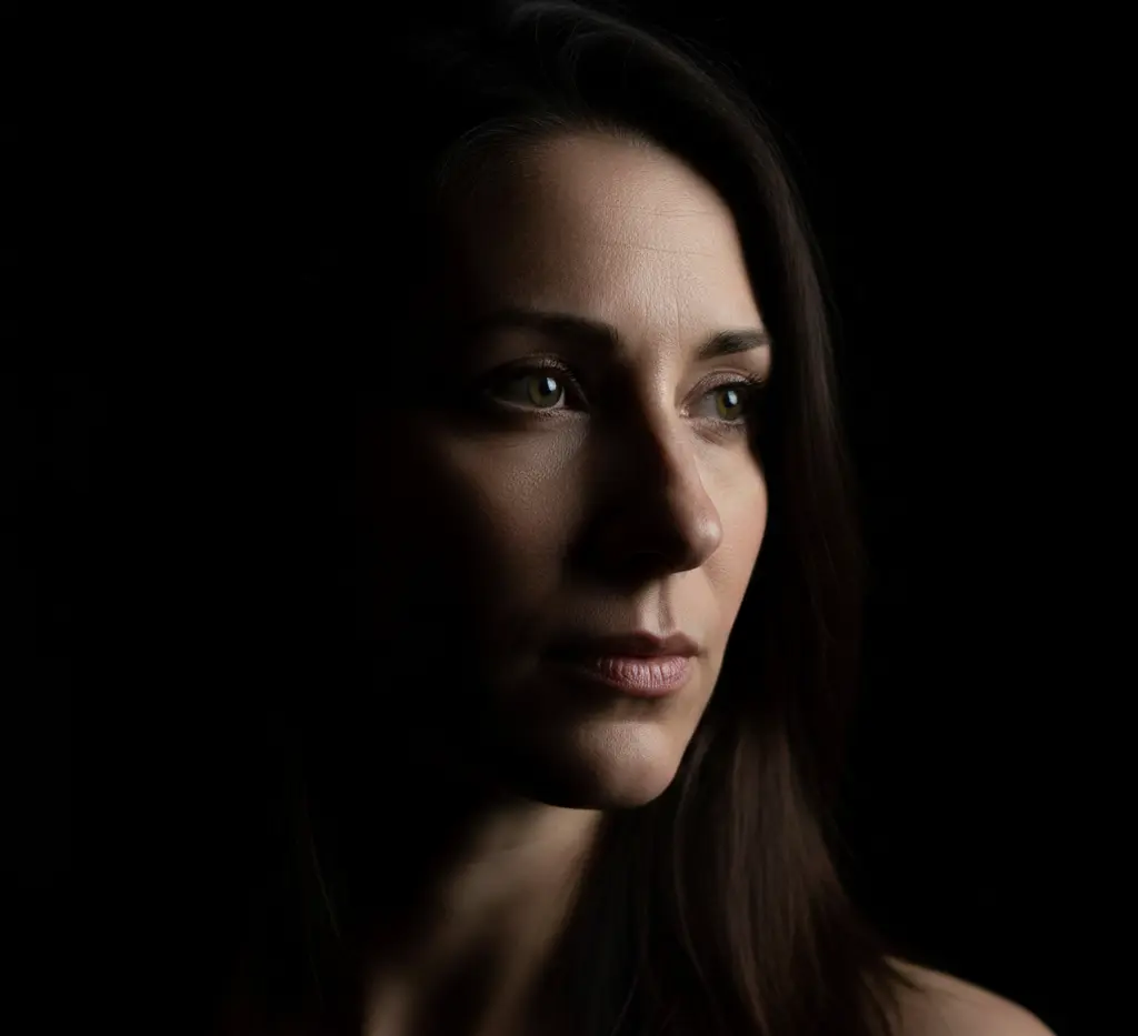 Dramatic low-key portrait with strong shadows